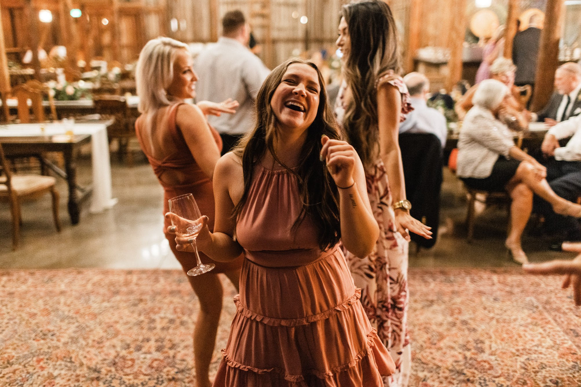 a young women smiles large while she dances