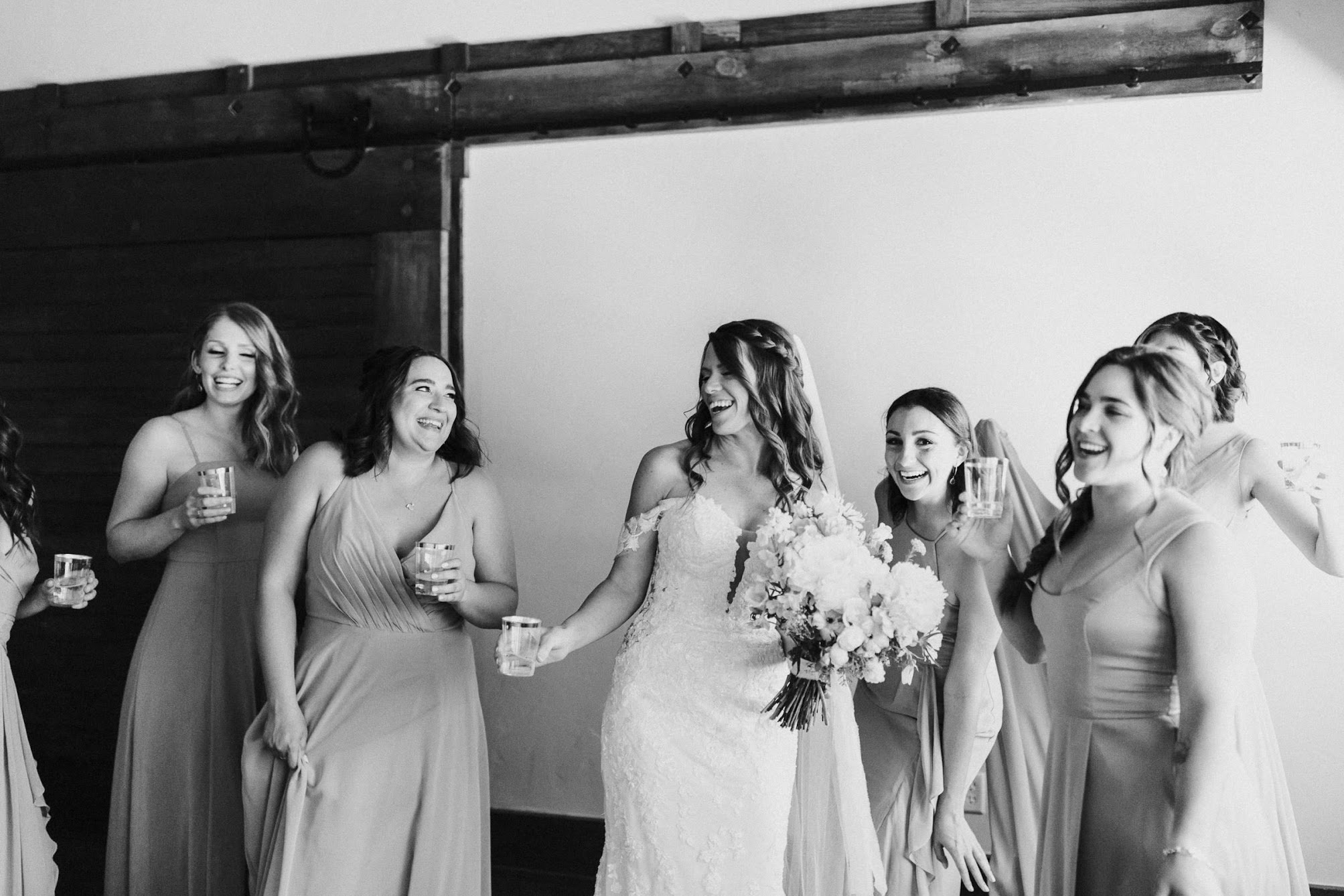 bride and the bridesmaids having a drink 