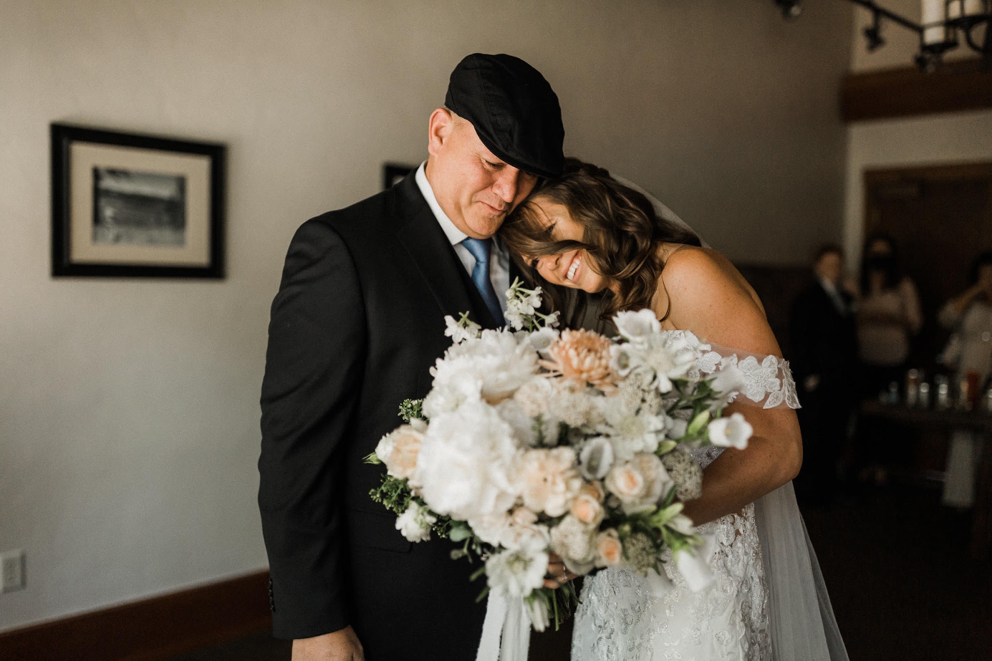 bride and her dad, bride is resting her head on his shoulder. 