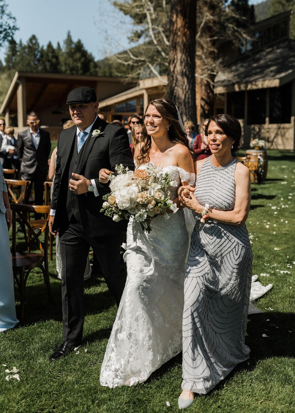 Bride walking down the aisle with her mom and dad 