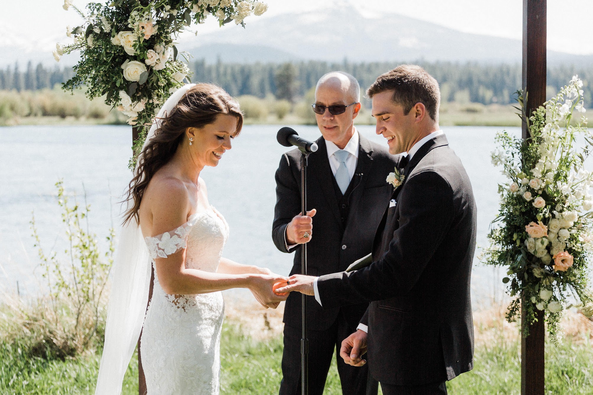 bride putting a ring on the groom 