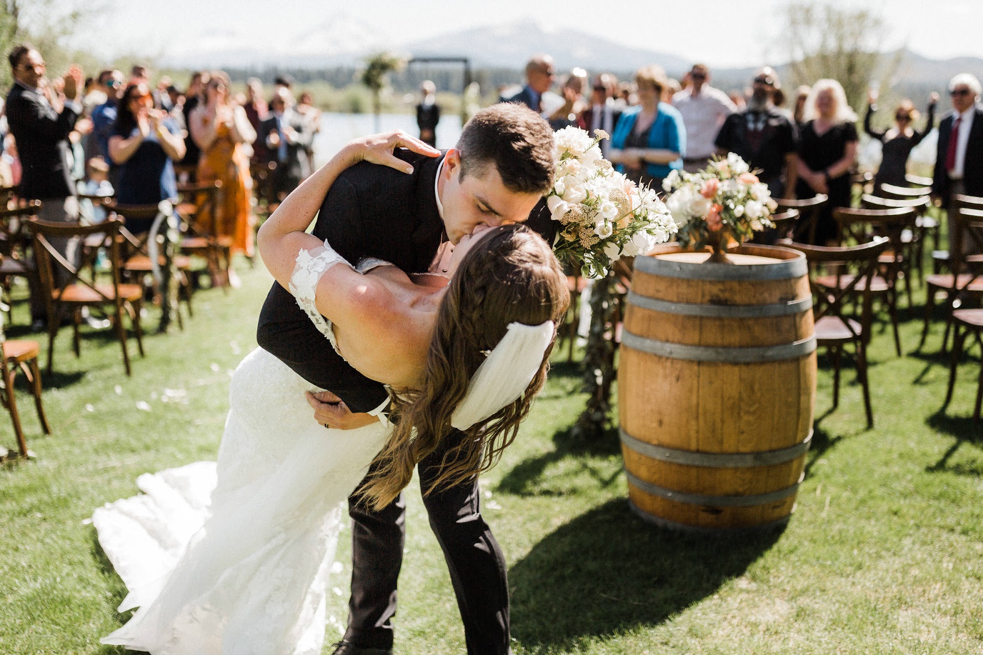 groom dipping the bride and kissing her at the ceremony.