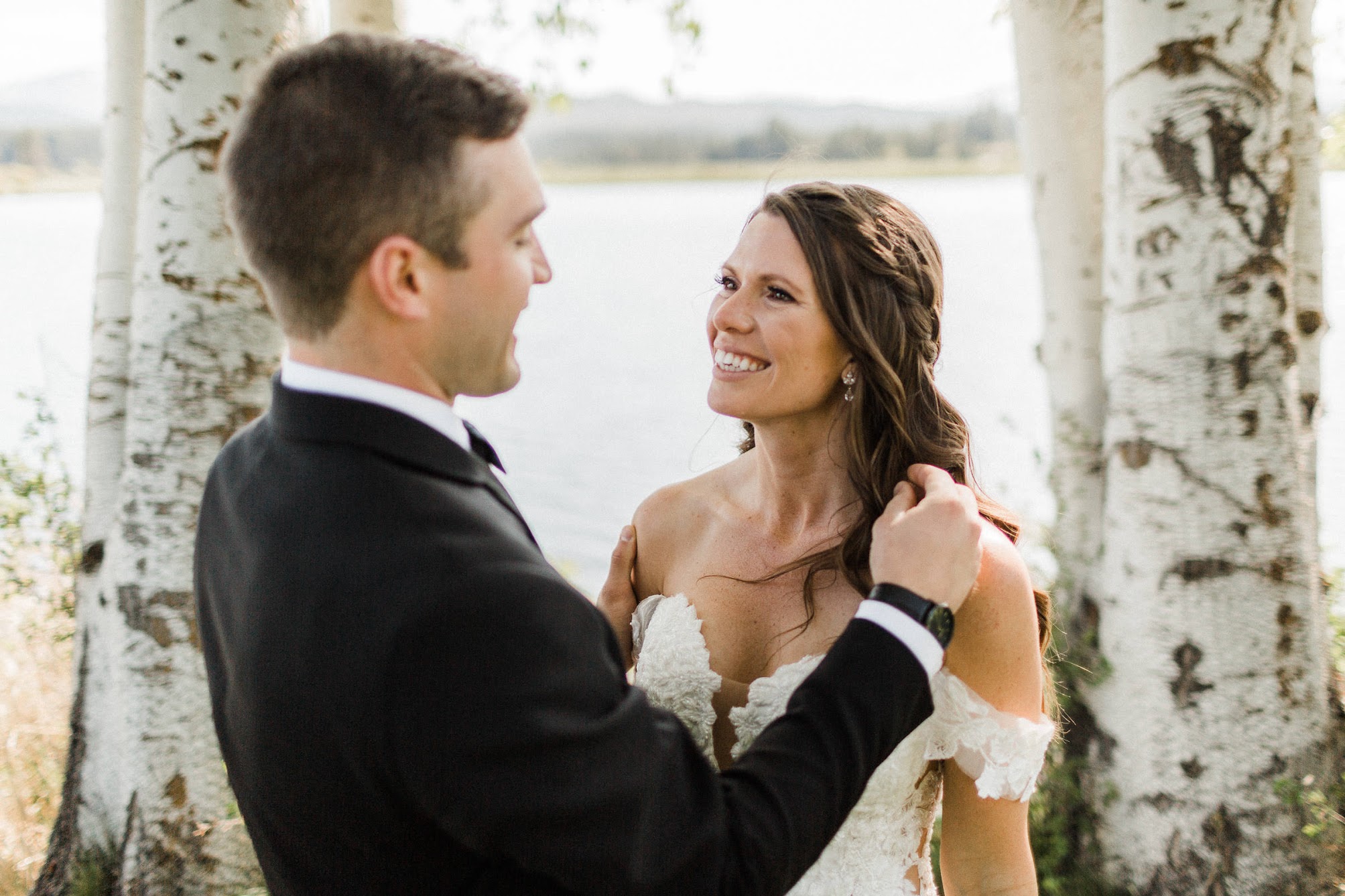 groom fixing the bride's hair