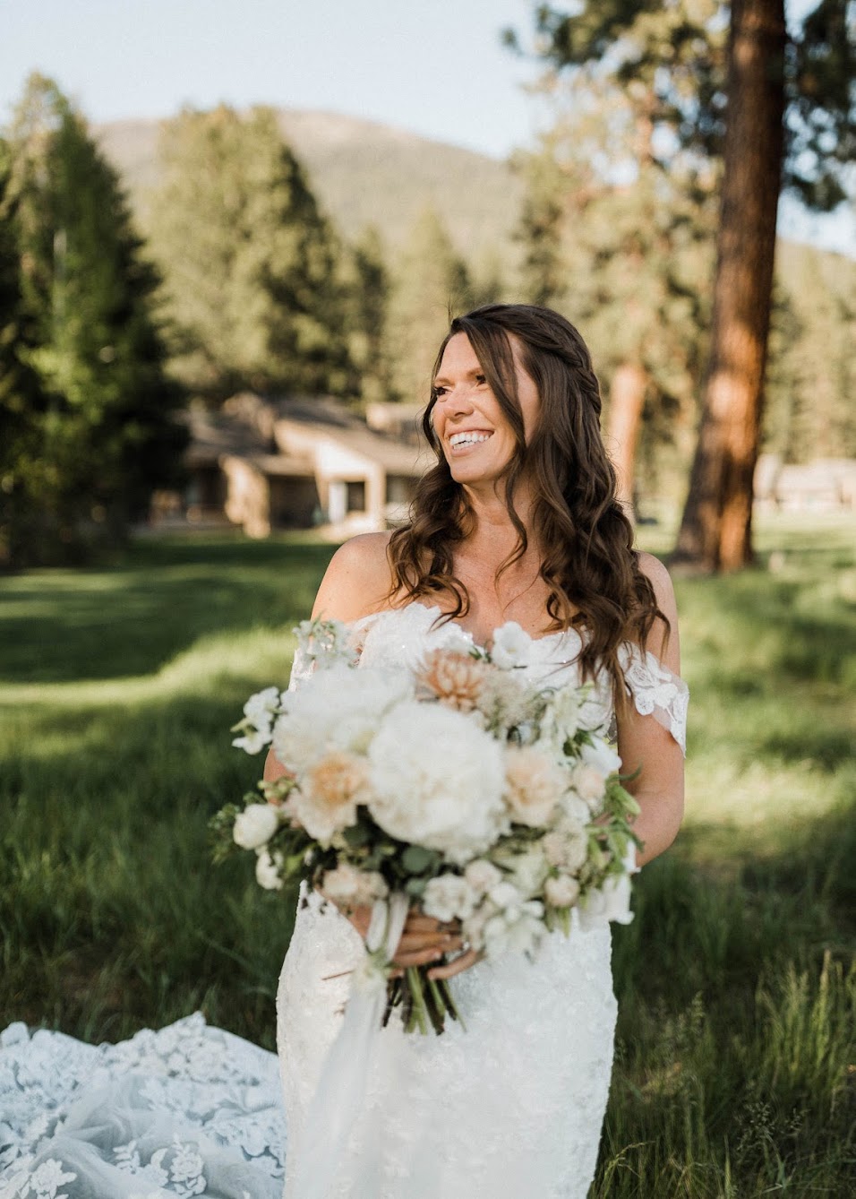 the bride standing outside with a big smile on 