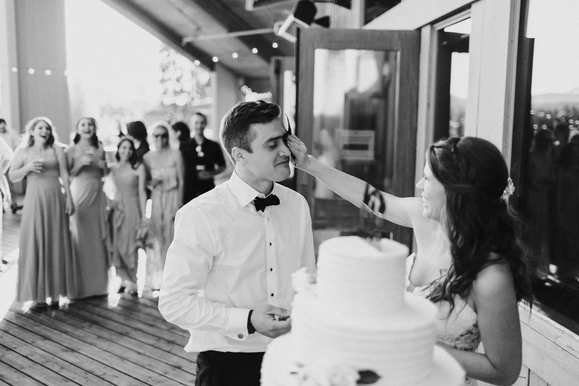 bride wiping cake off the groom's face 