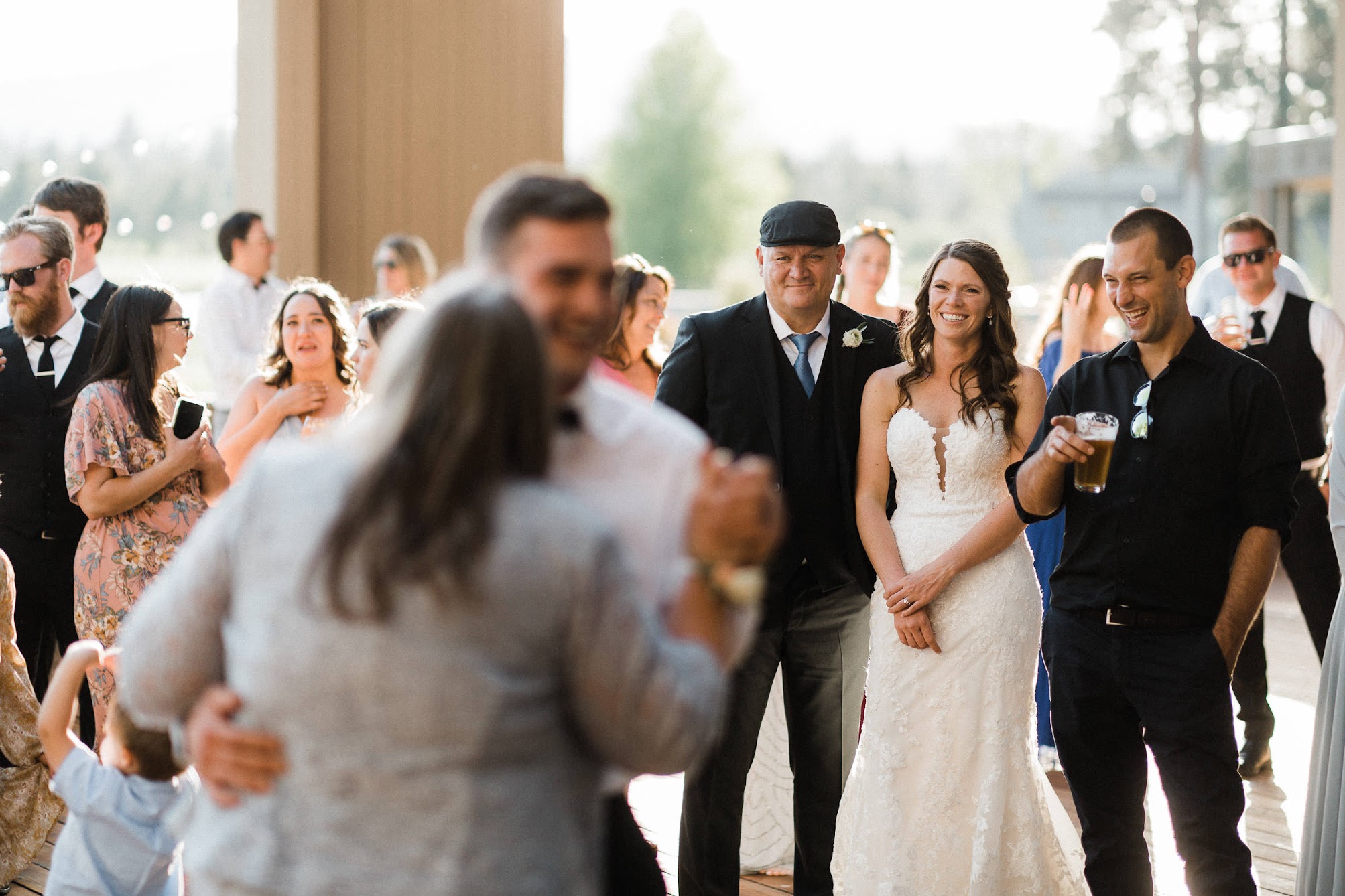 bride watching the groom dance with his mom.