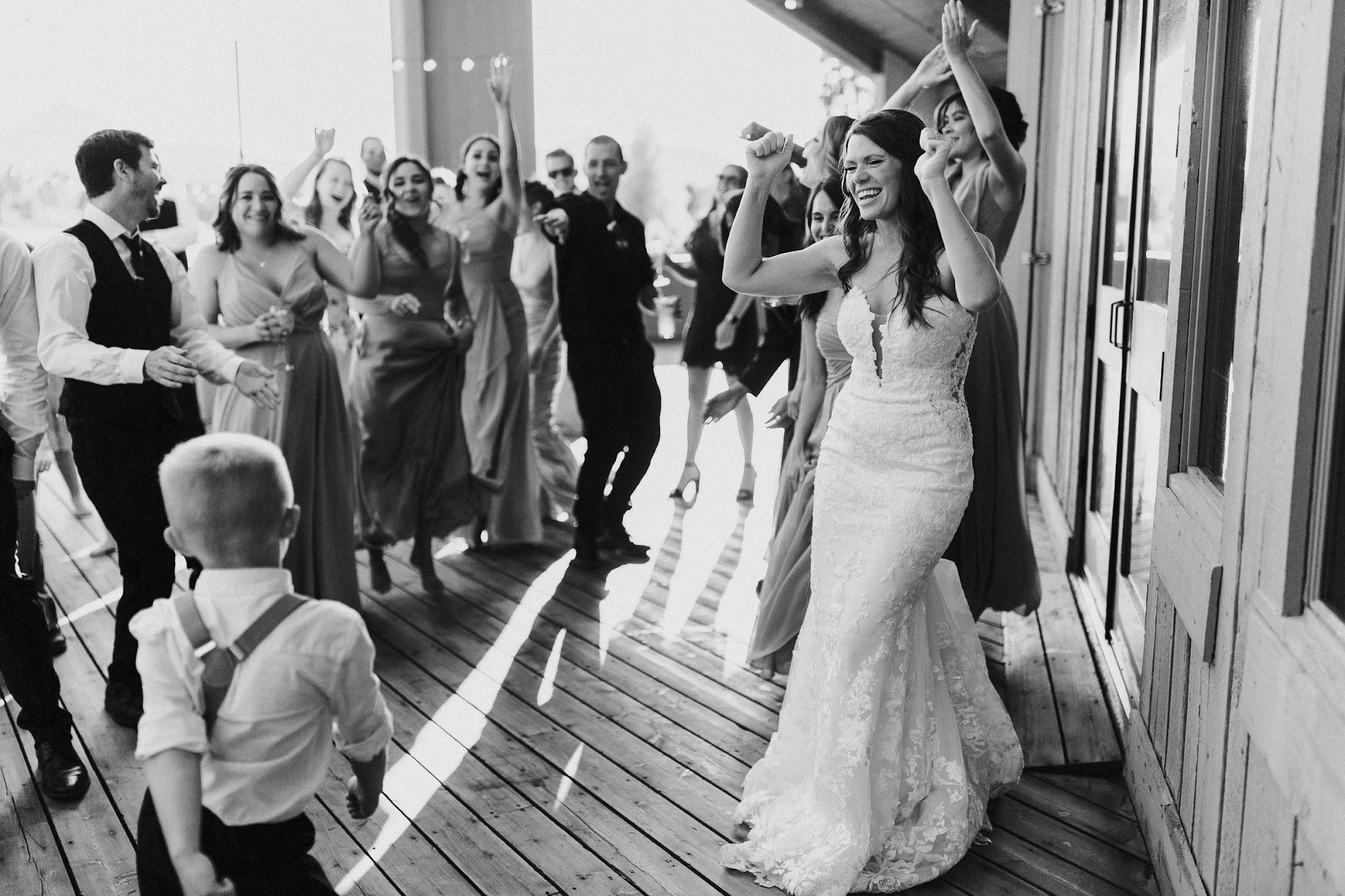 bride and all their guests dancing on the deck 