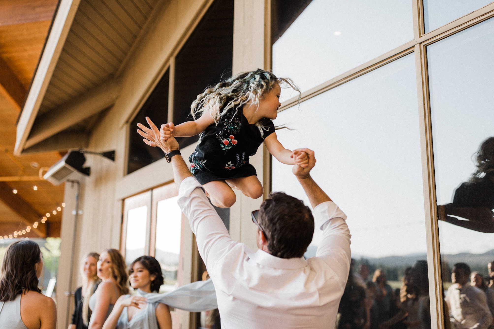 little girl being thrown in the air while dancing 