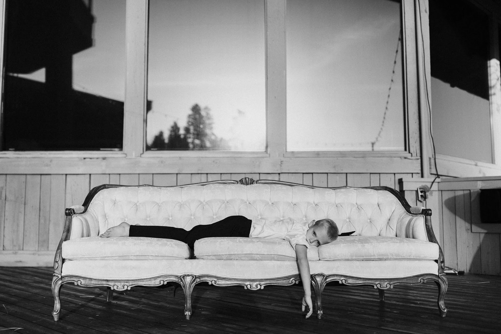 little boy laying on the couch 