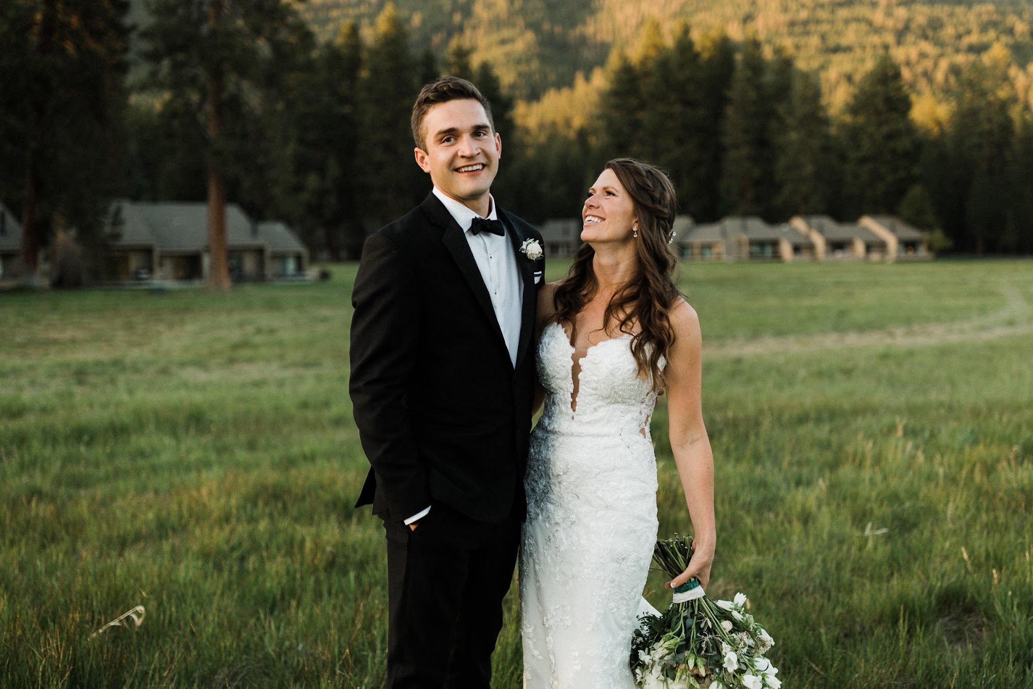 Bride and groom portrait outside with the sunset behind them 