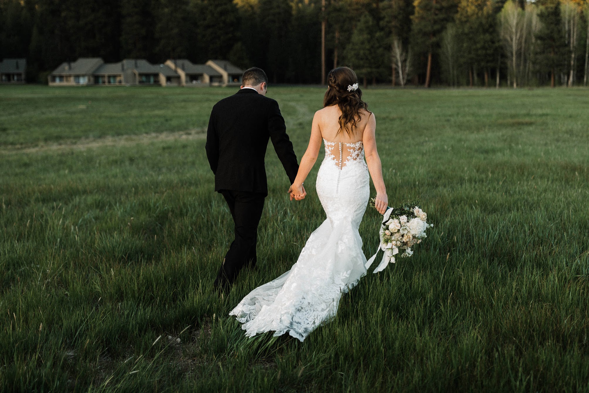 bride and groom walking away holding hands