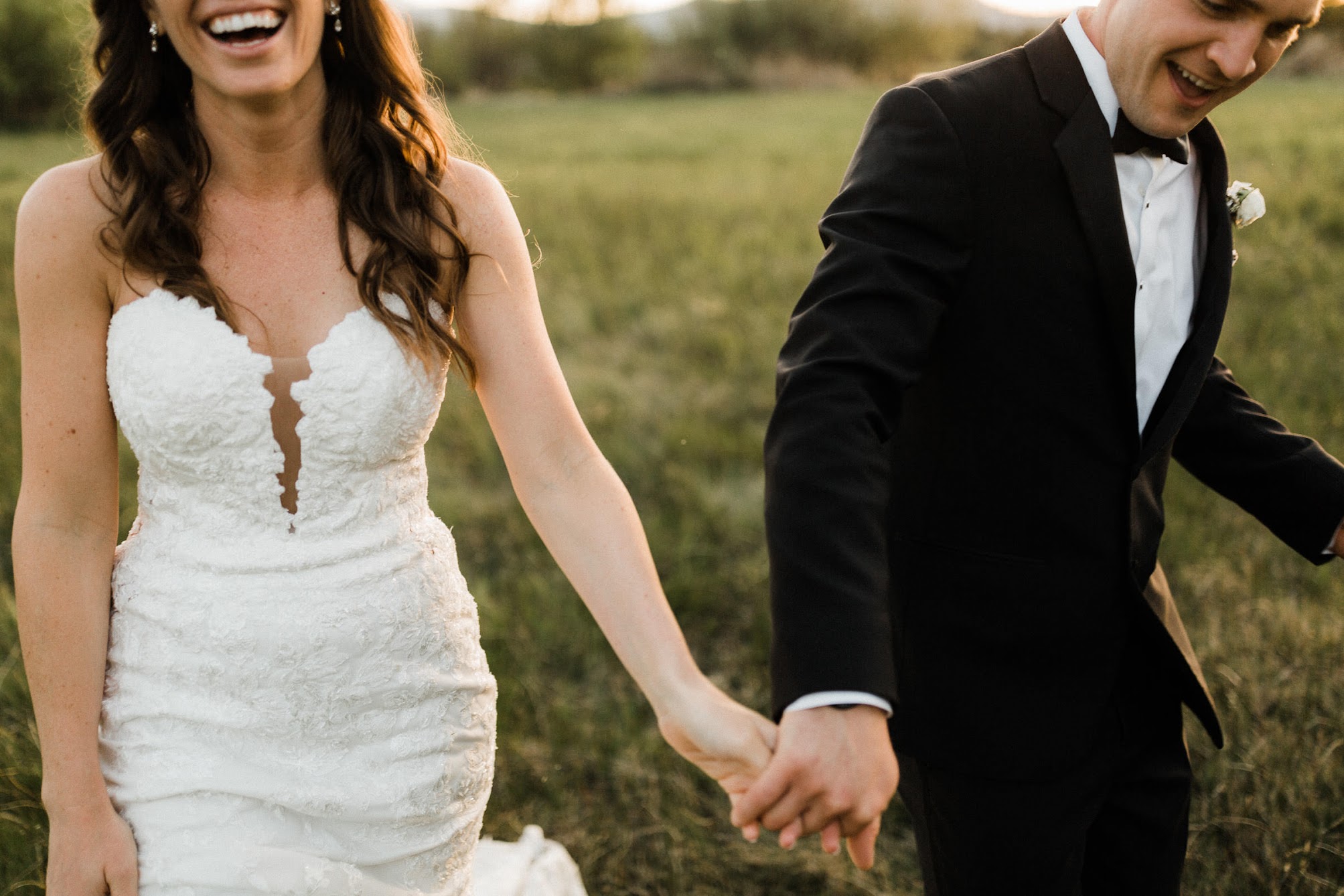 bride and groom walking with each other holding hands
