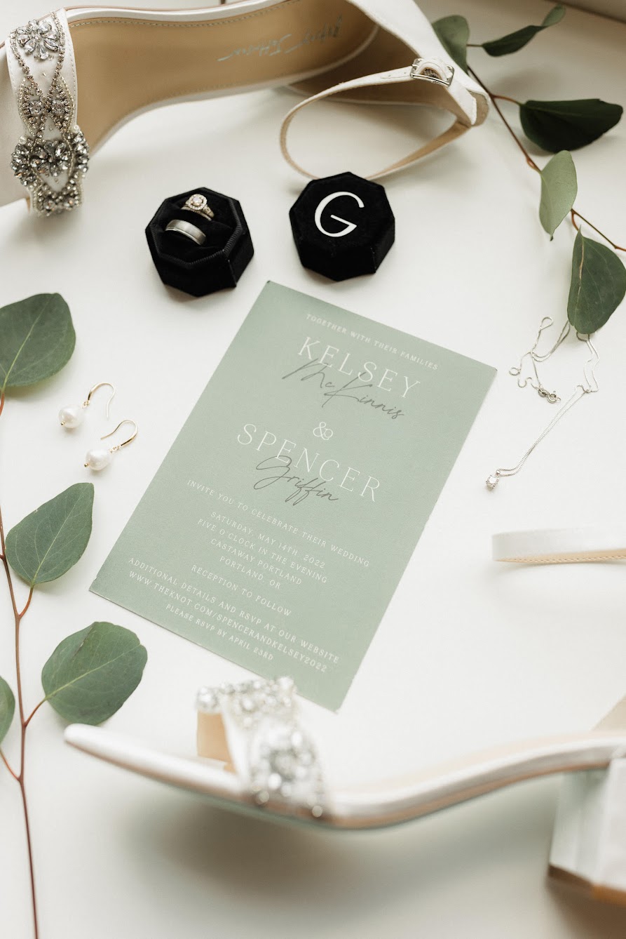 Kelsey and Spencer's wedding invite telling their guests to meet them at Castaway Portland for their celebration 
