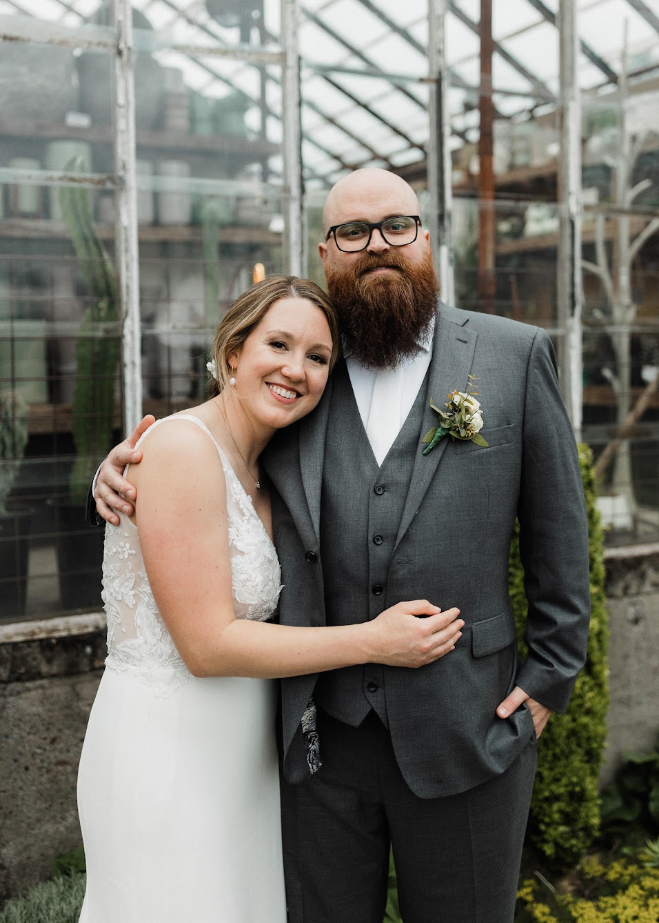 bride and groom hugging each other in a garden 