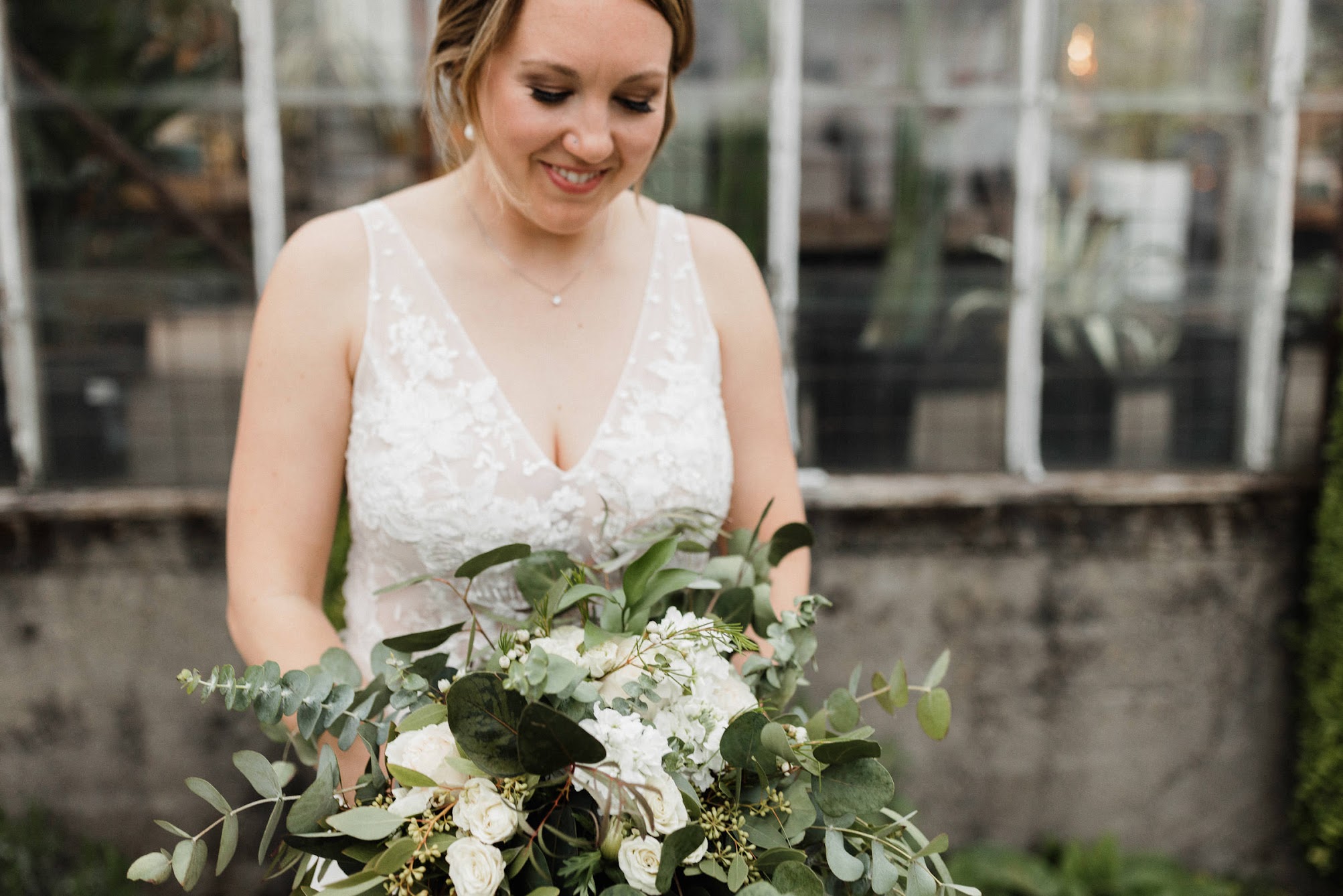 bride looking at her lovely bridal bouquet 