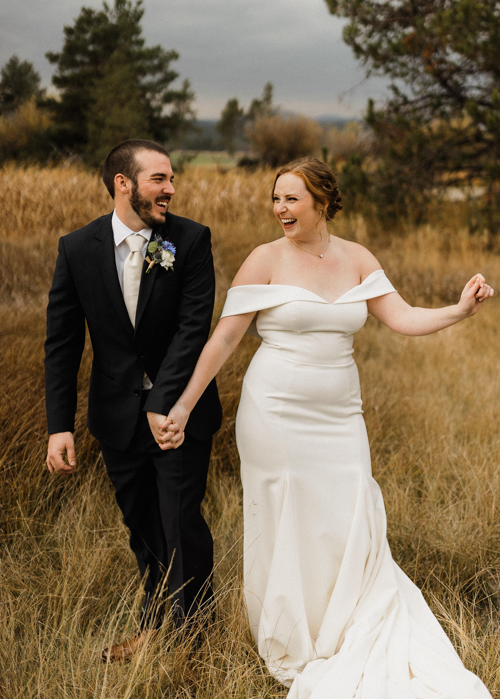 Bride and groom pose for portraits in a field at Sunriver Resort
