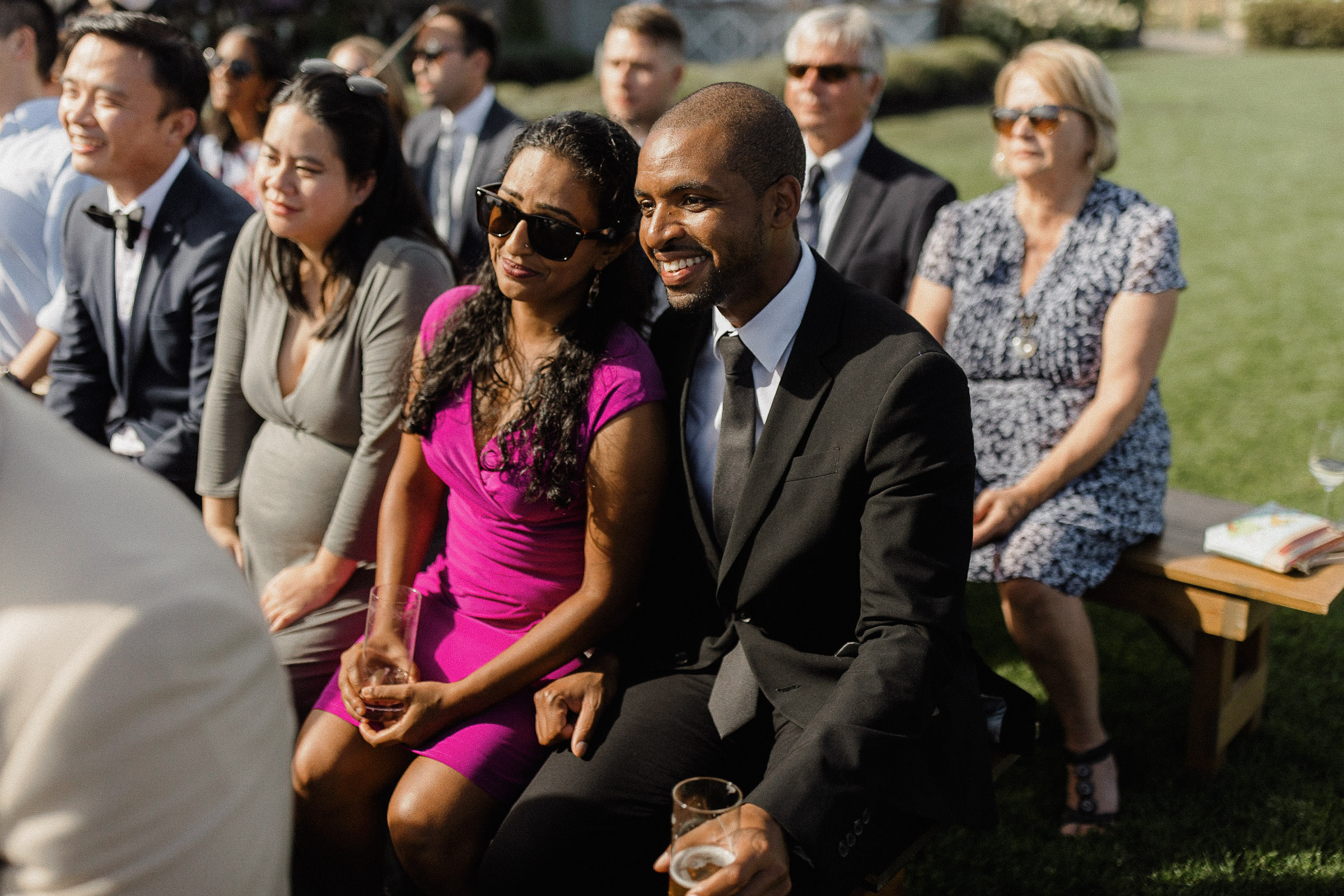 Guests smile during wedding ceremony