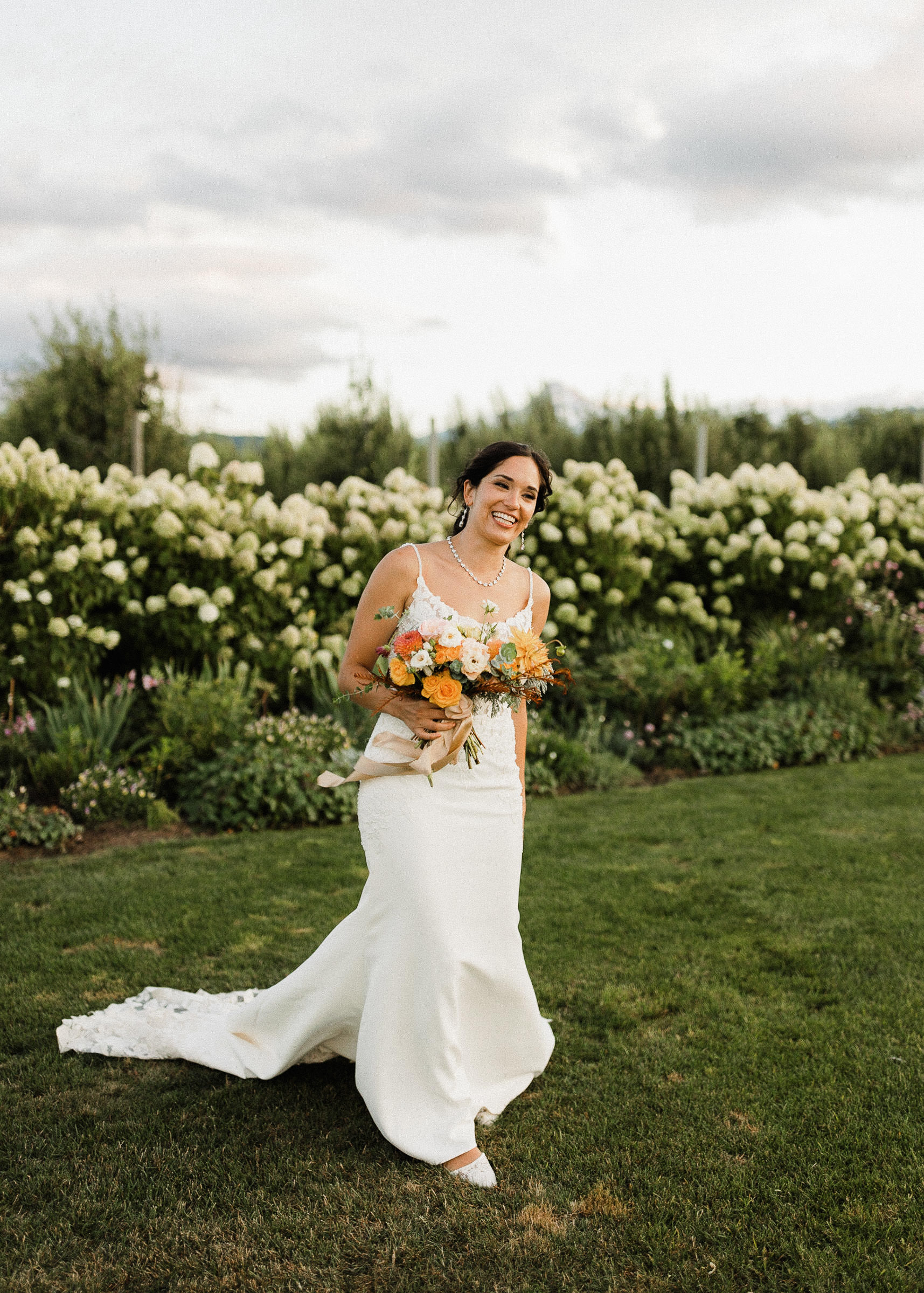 Bride poses for a portrait at The Orchard