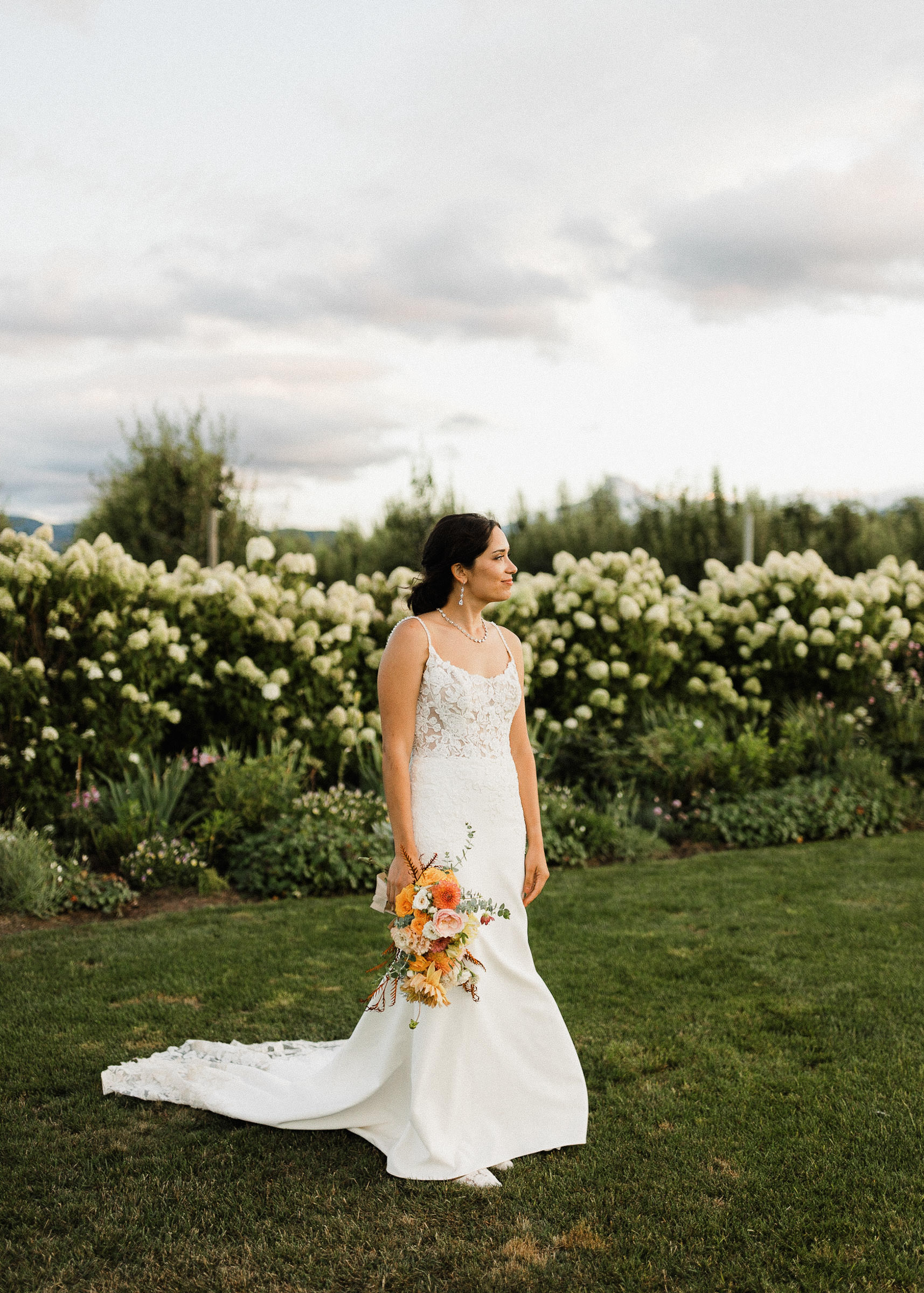 Bride poses for a portrait at The Orchard