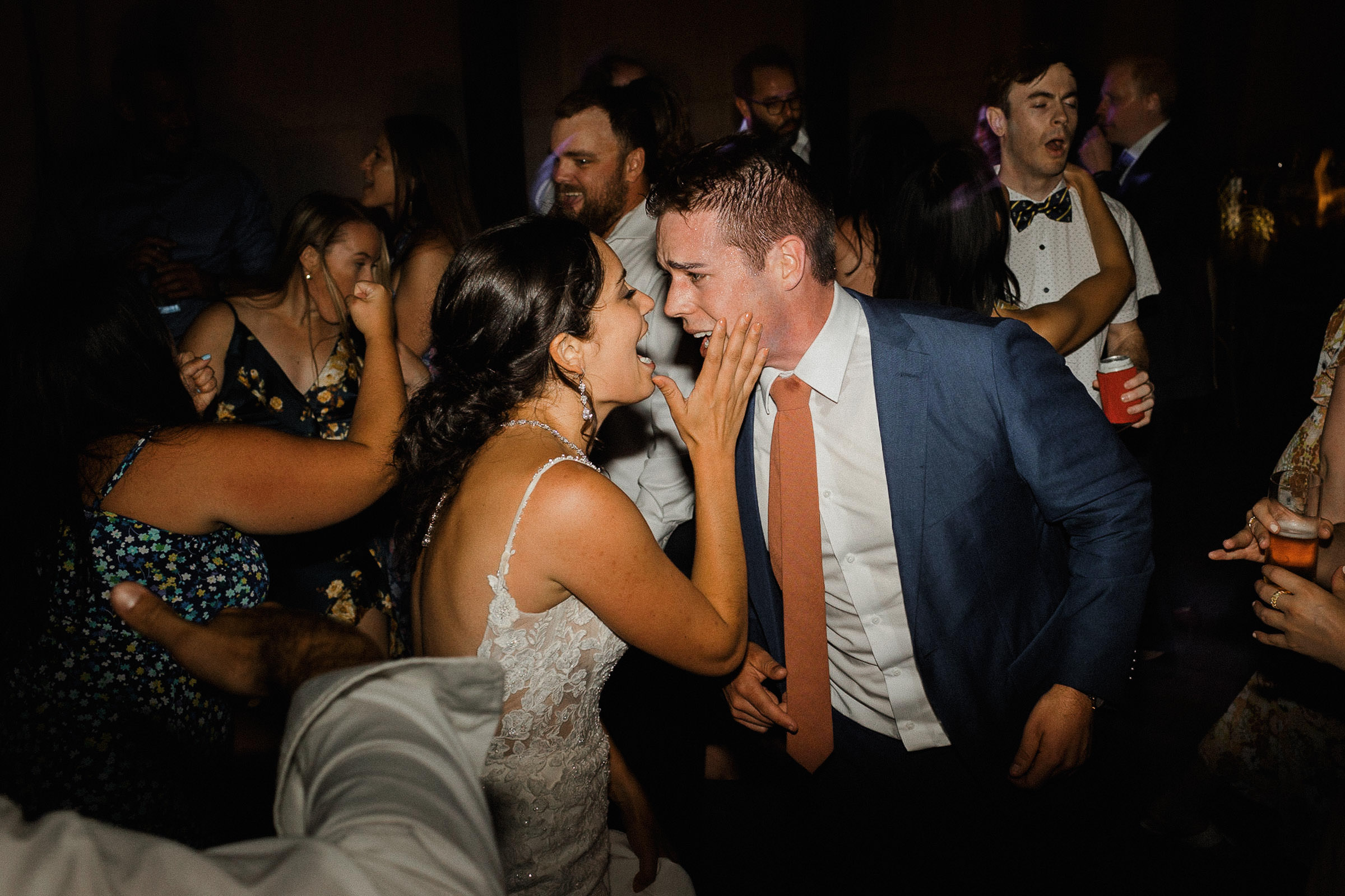 Bride and groom sing along to a song together on the dance floor