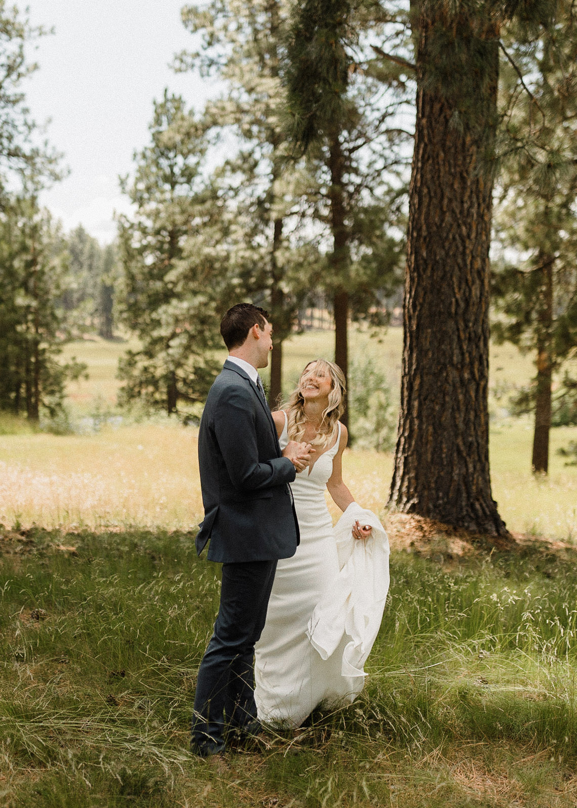 Bride sees groom for the first time during their "first look" in a field