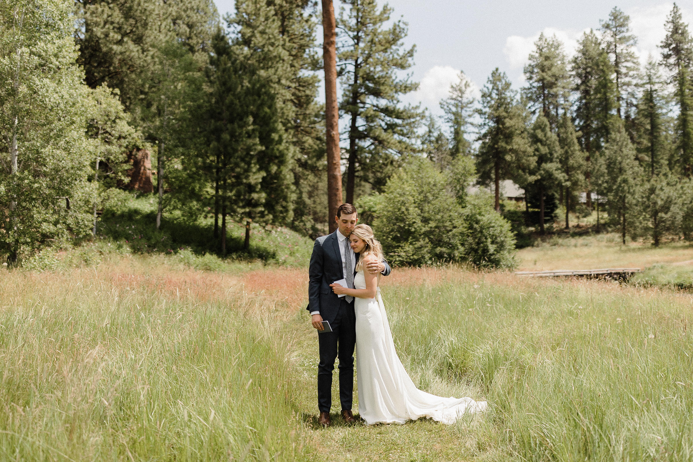 Bride and groom share an emotional embrace after their private vow reading