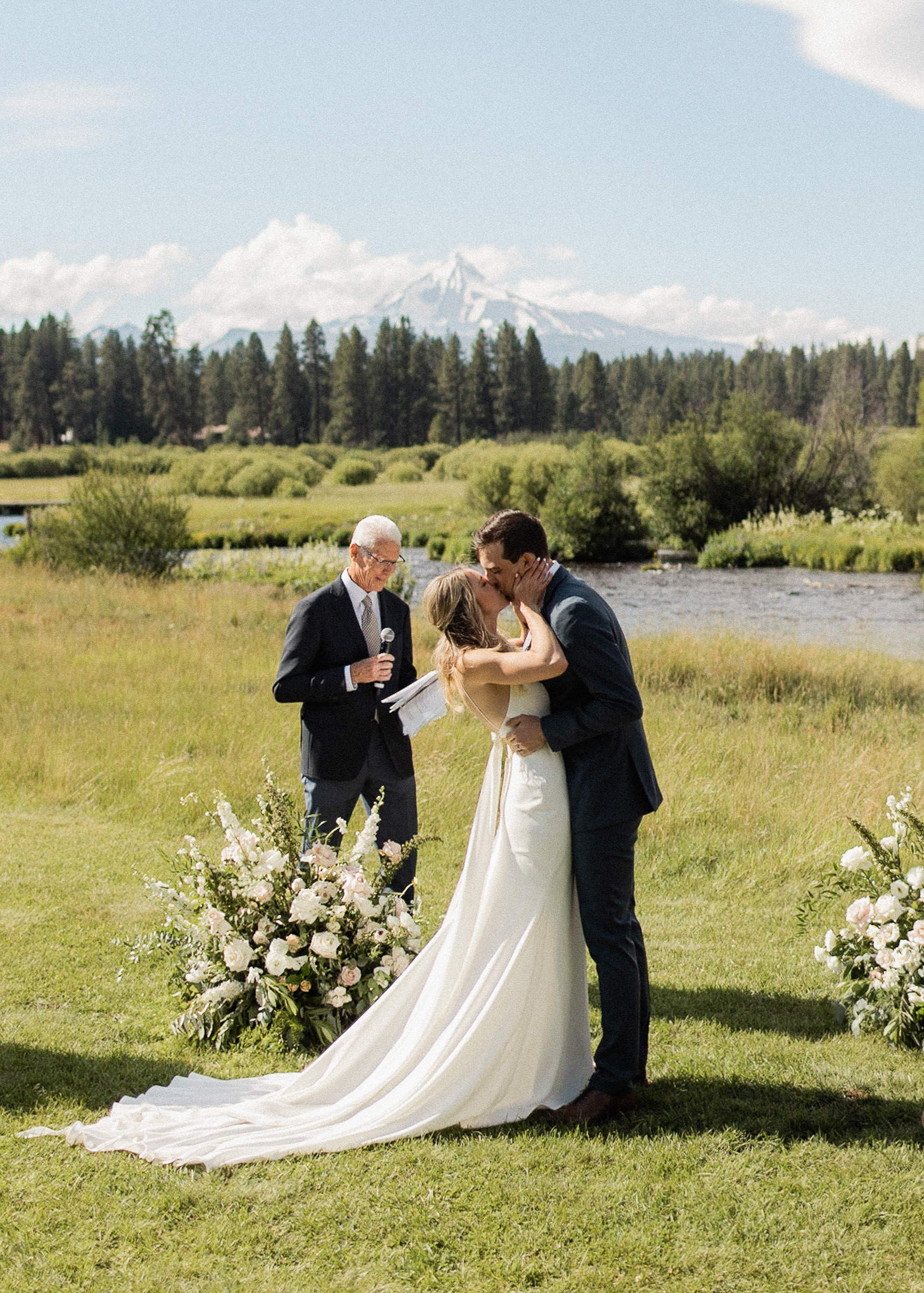 Bride and groom kiss at the end of wedding ceremony