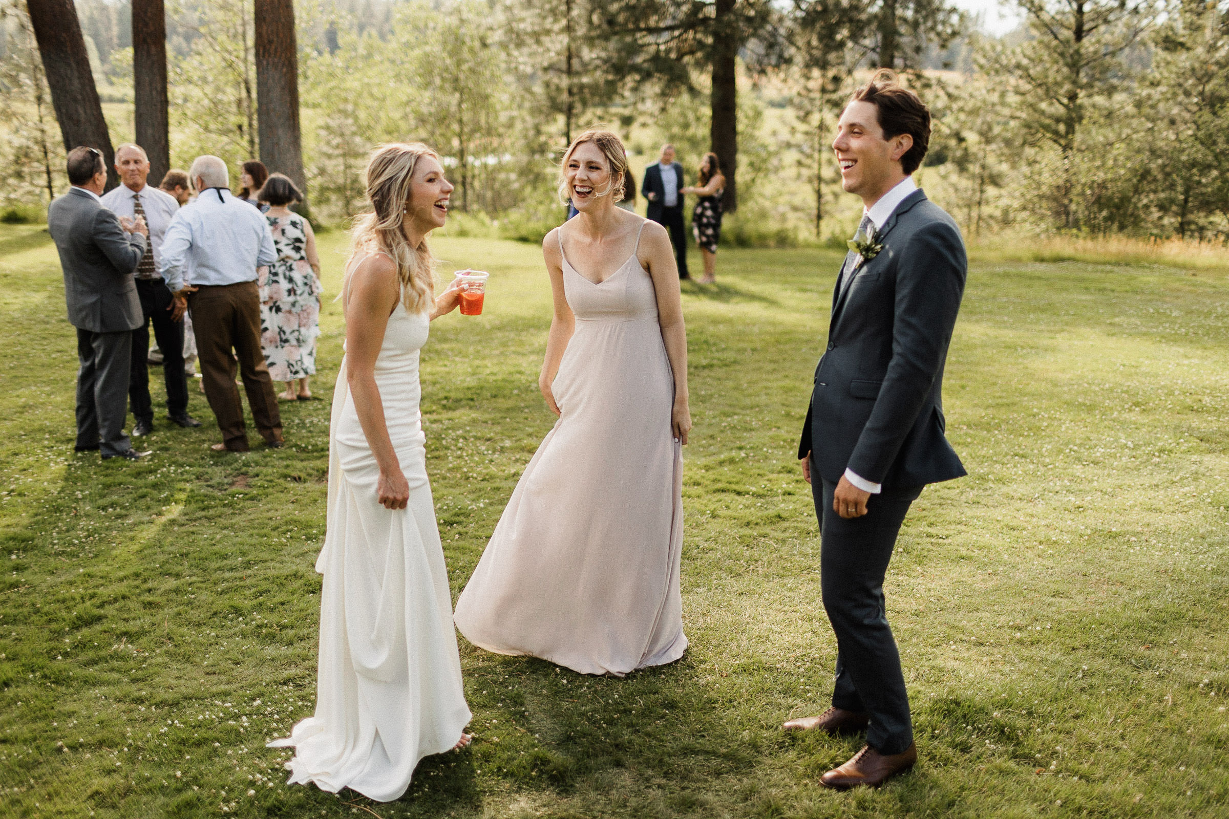Bride laughs with friends during cocktail hour