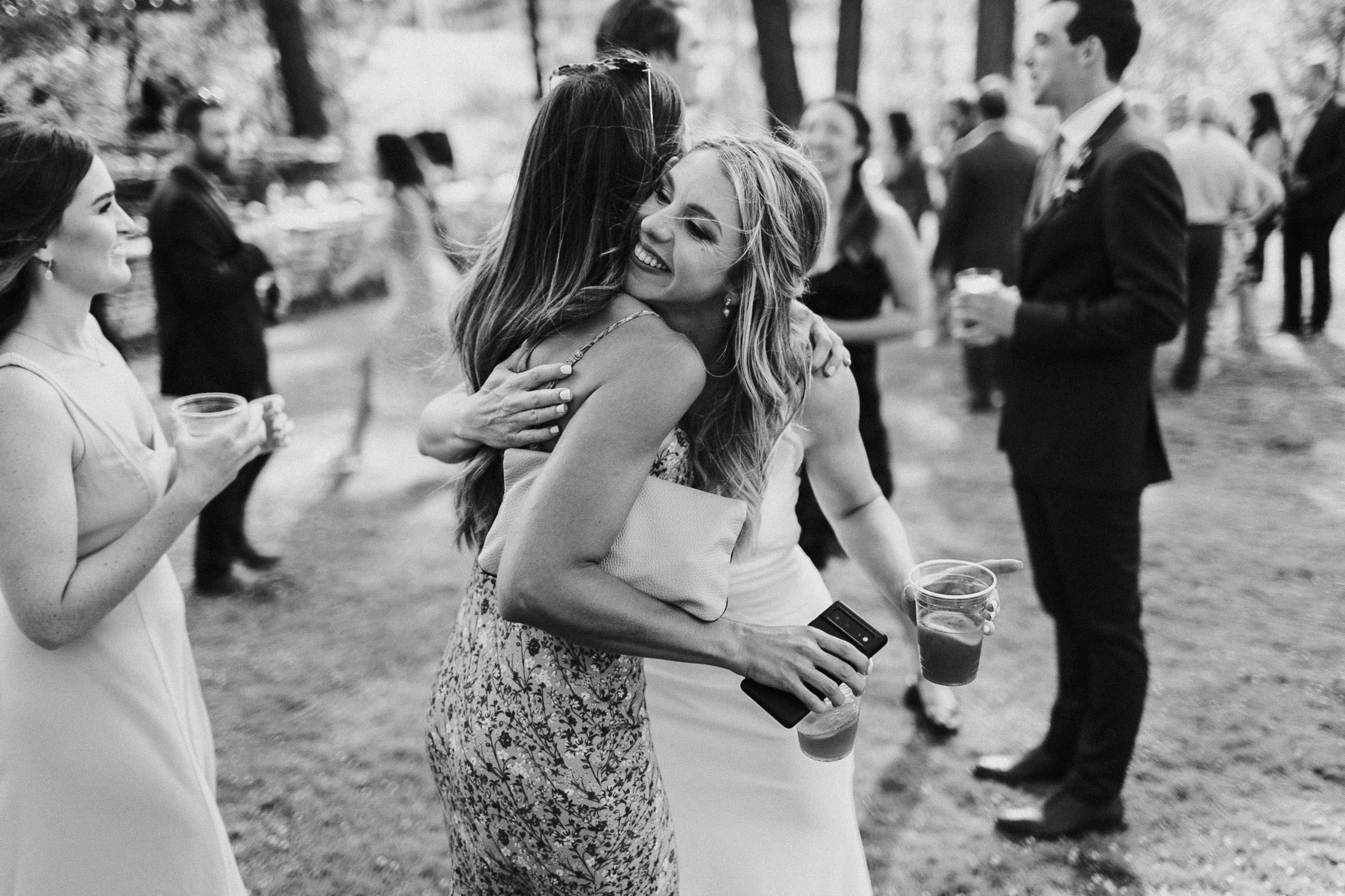 Bride hugs a guest during cocktail hour
