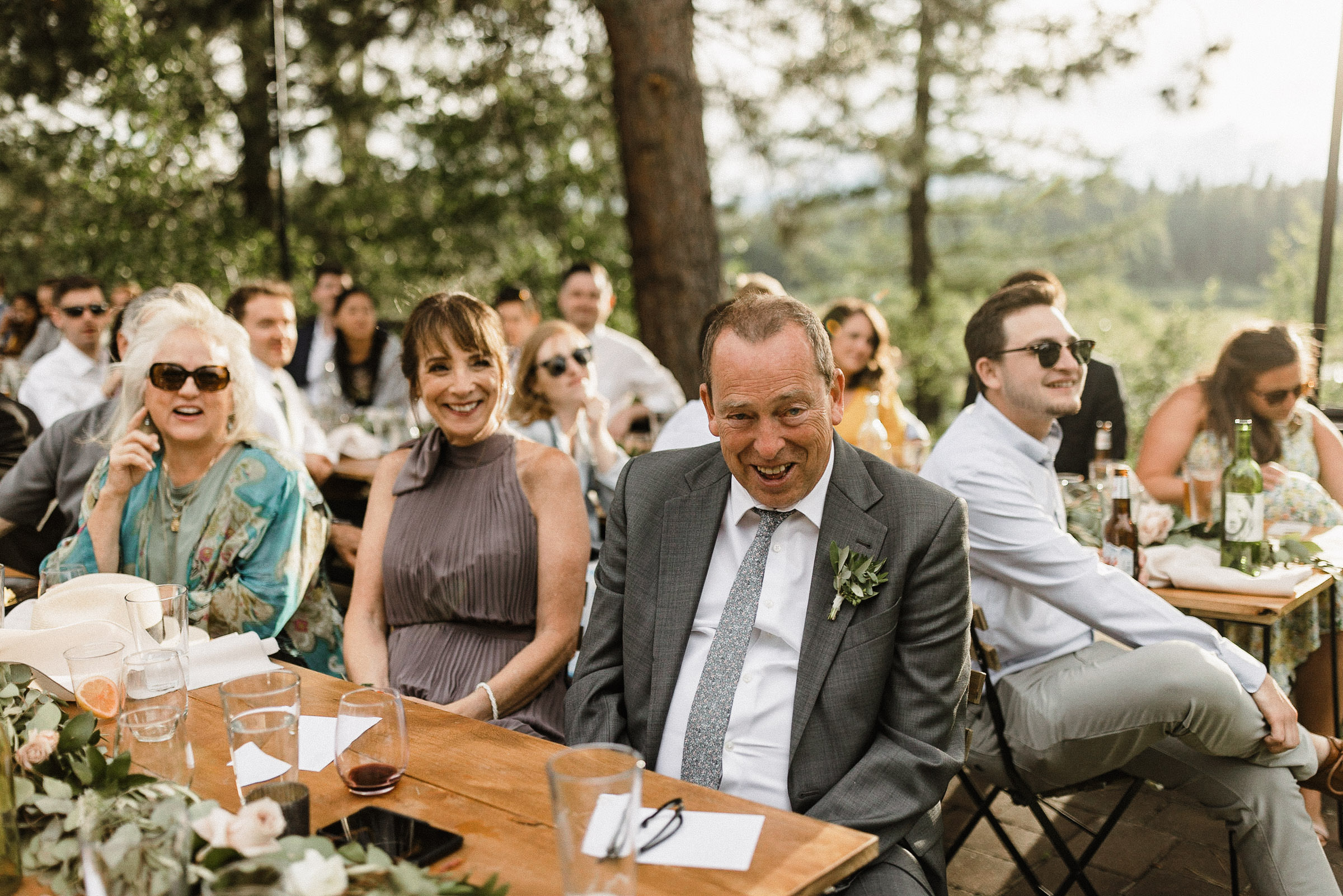 Groom's parents laugh during a toast