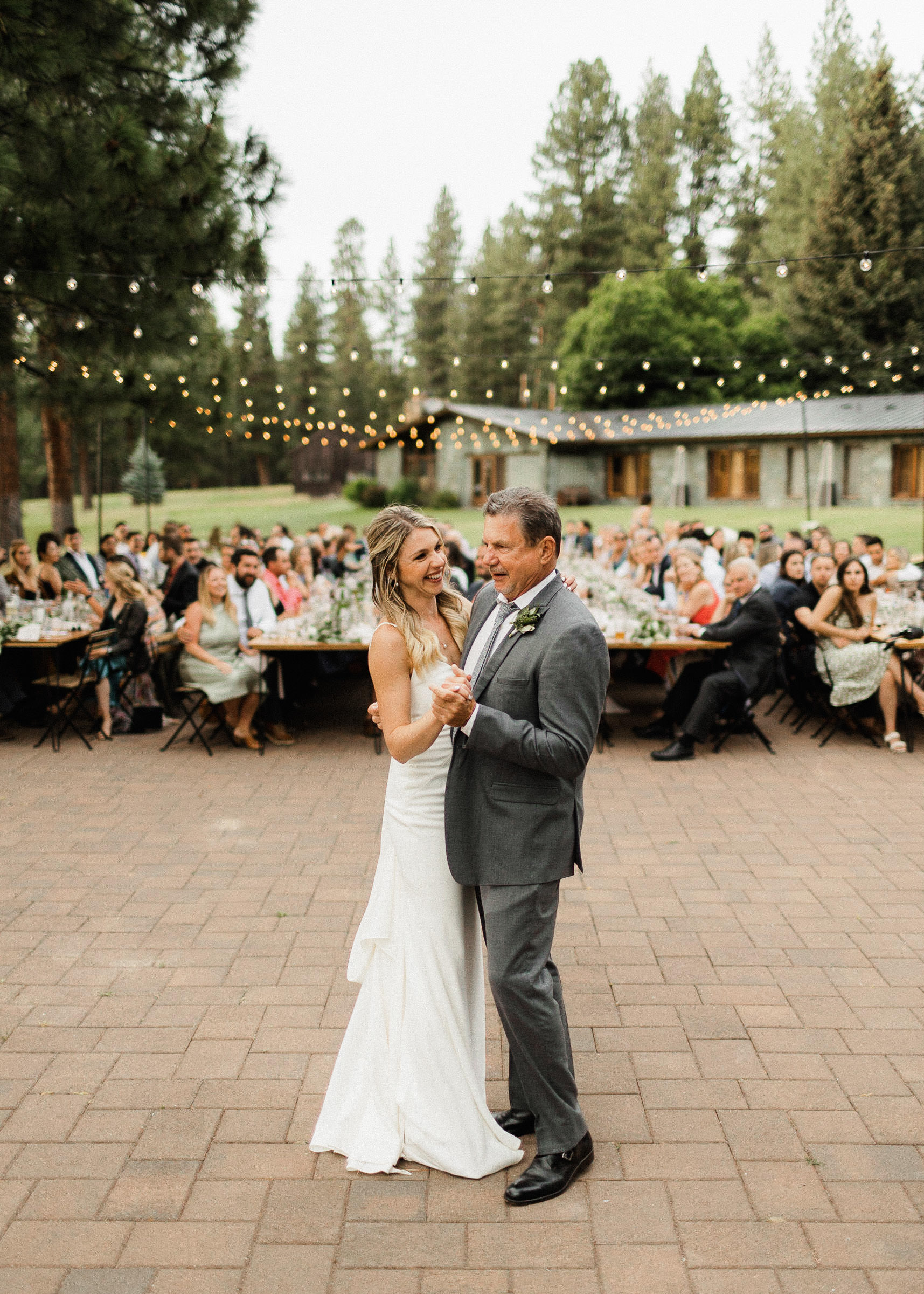 Bride and father dance together