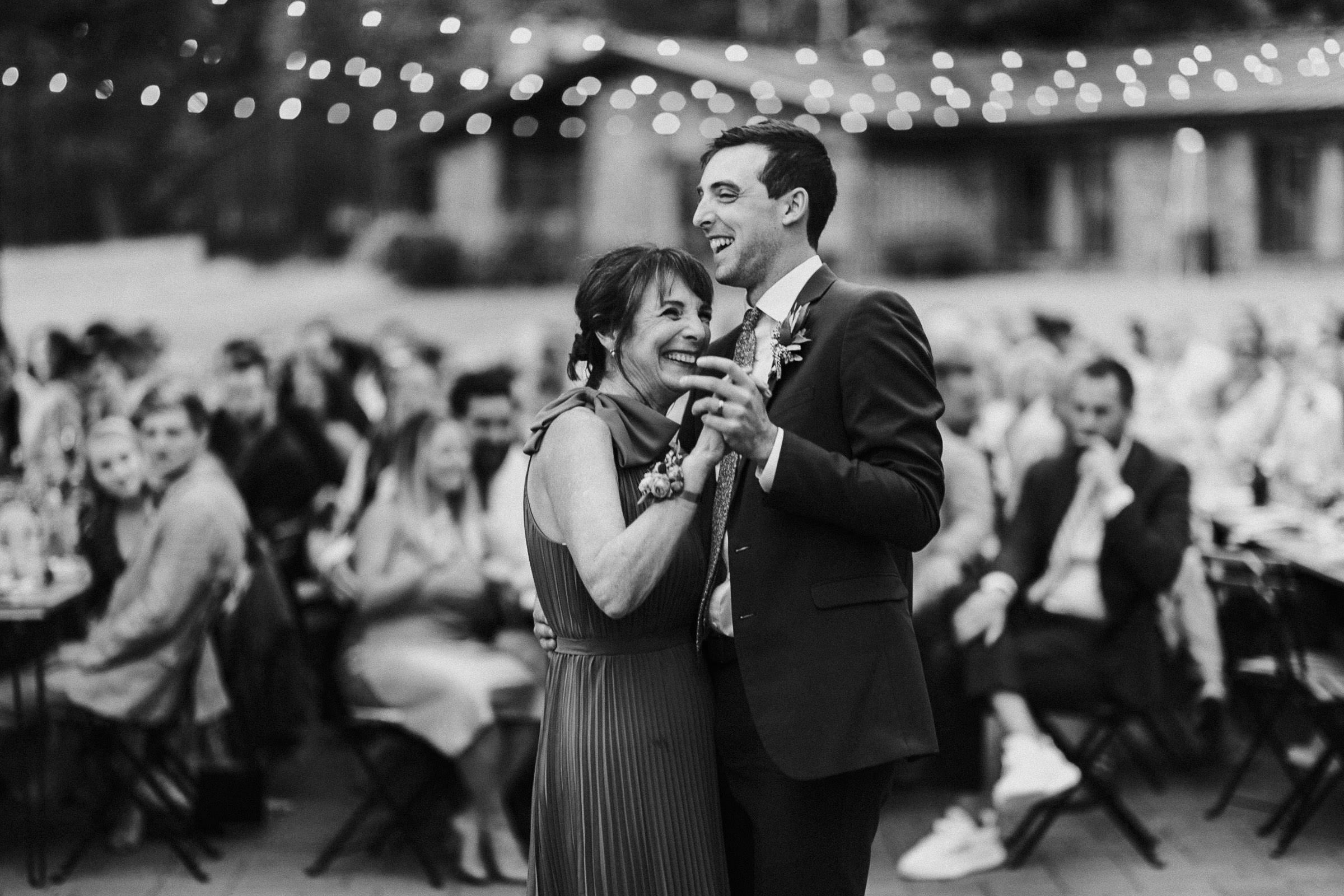Groom and his mom dance together
