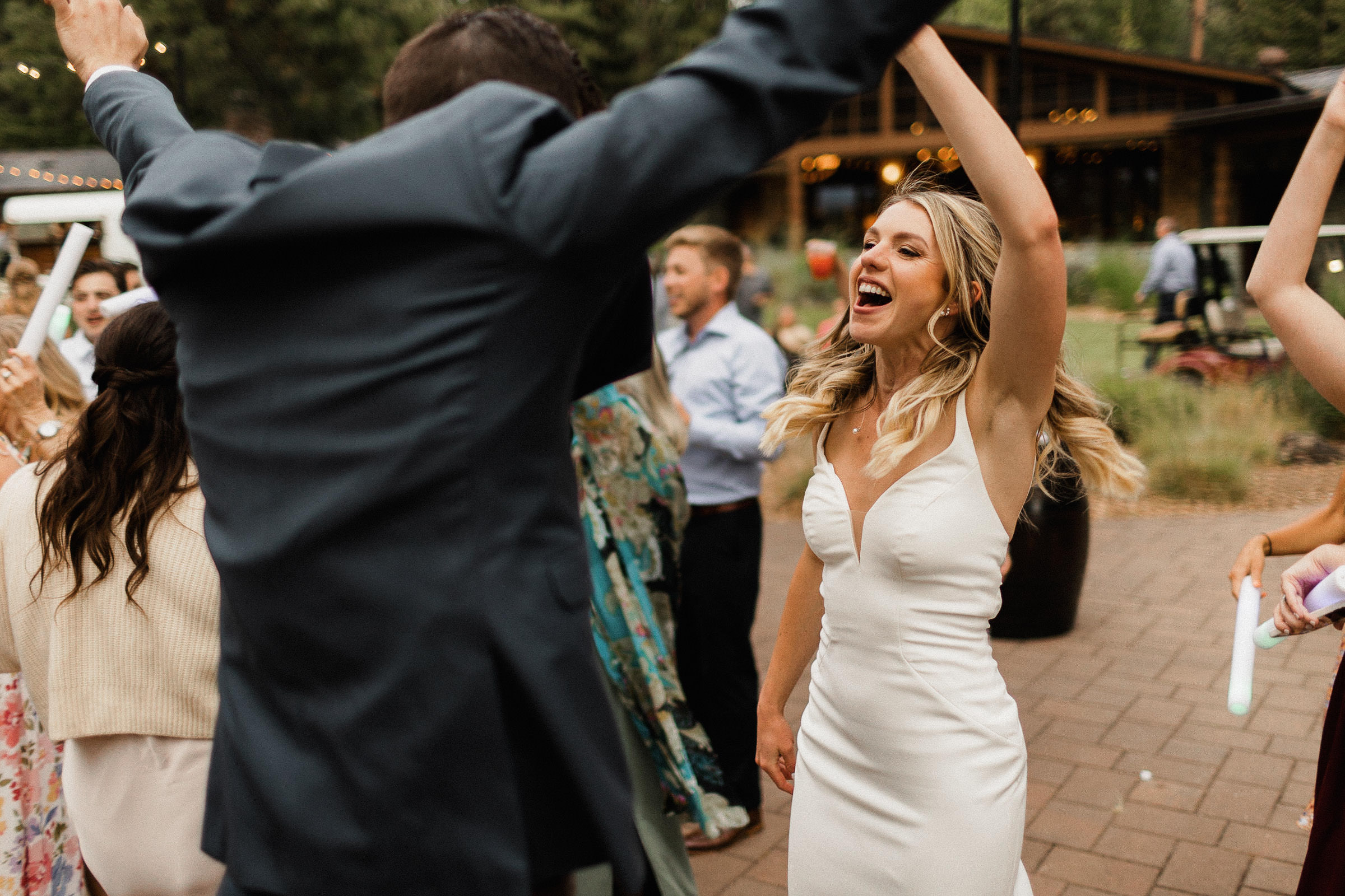 Bride dances during outdoor reception 