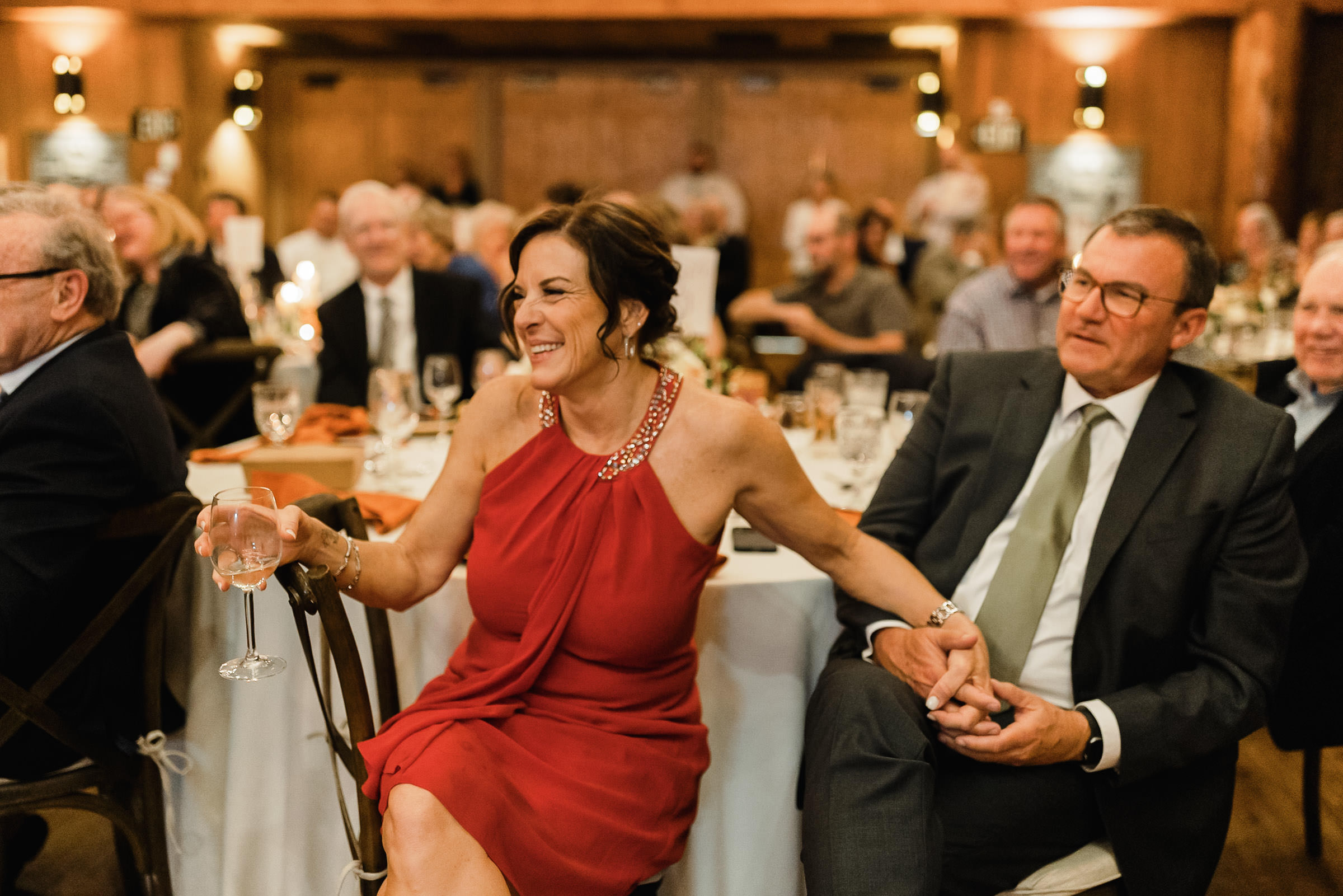 Groom's parents laugh during toasts